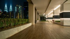 an empty hallway with a view of the city at night at Harmony Luxury Suites At TM Persiaran Stonor KLCC in Kuala Lumpur
