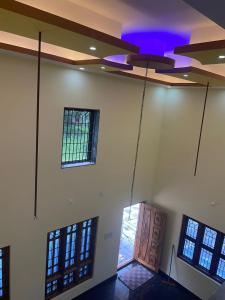 a room with a ceiling with a purple light at Holy spirit Arul lobo Peace in Kalyānpur