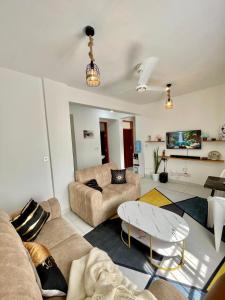 a living room with two couches and a table at Imali homes in Mombasa