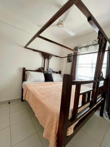a bedroom with a wooden bed in a room at Imali homes in Mombasa