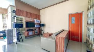 a living room with a couch and a red door at SpringHills Villa Panderman Batu - Private Pool in Tlekung