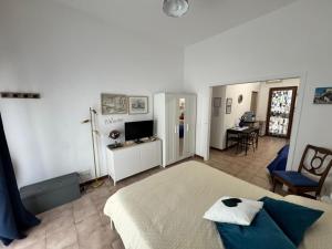a bedroom with a bed and a living room at Casa AZZURRA in Giovinazzo