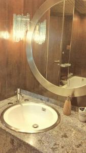 a bathroom with a sink and a large mirror at B&B Le Terrazze in Bologna