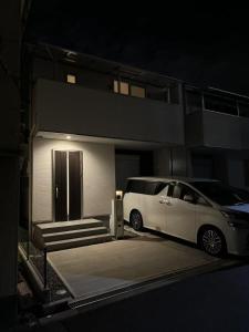 a white van parked in front of a building at 花喜Usj in Osaka +9 photos