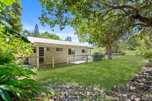 a home with a large yard in front of it at At Melaleuca 3 in Point Lookout
