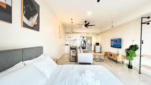 a bedroom with a bed and a living room at Tulip Residences by Manhattan Group in Shah Alam