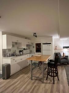 a kitchen with a table and chairs in a room at Michaud's Basement unit in Nakusp