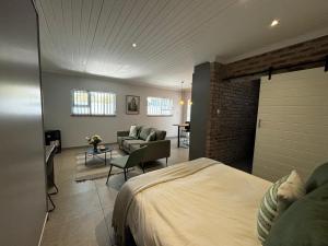 a bedroom with a bed and a living room at Prospect Cottage in Walmer