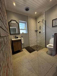 a bathroom with a shower and a toilet and a sink at Prospect Cottage in Walmer