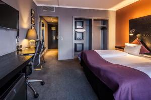 a hotel room with a bed and a desk at Scandic Front in Copenhagen
