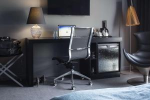 a desk with a computer monitor and a chair at Scandic Front in Copenhagen