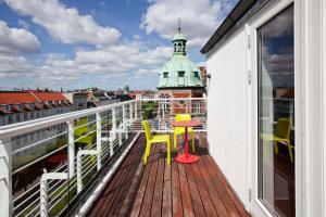 a balcony with a table and chairs on a building at Scandic Front in Copenhagen