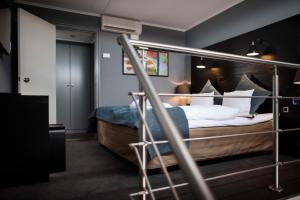 a bedroom with a bed with white sheets and pillows at Scandic Front in Copenhagen