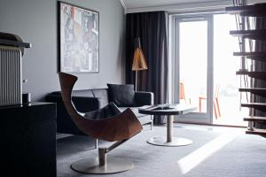 a living room with a chair and a table at Scandic Front in Copenhagen