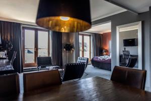 a room with a dining table and a bedroom at Scandic Front in Copenhagen