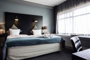 a bedroom with a large bed with a window at Scandic Front in Copenhagen