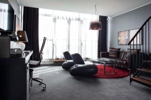 a living room with two chairs and a table at Scandic Front in Copenhagen