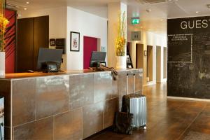 a hotel lobby with a luggage counter at Scandic Front in Copenhagen