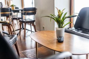 a plant sitting on a wooden table with chairs at Scandic Front in Copenhagen
