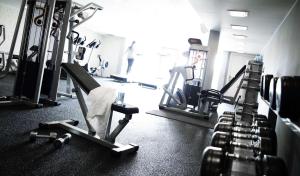 a gym with several treadmills and machines at Scandic Front in Copenhagen