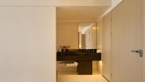 bagno con lavandino nero e specchio di 西塘光向度艺术酒店WNDR Hotel Xitang a Jiaxing