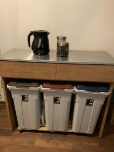 a counter with three trash cans under a table at Seven House Family room in Kurume +29 photos