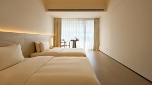 Letto o letti in una camera di 西塘光向度艺术酒店WNDR Hotel Xitang