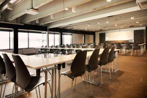a conference room with a long table and chairs at Scandic Vulkan in Oslo