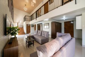 a living room with a large couch and a table at The Warehouse Loft in Baguio