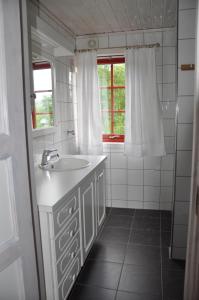 a white bathroom with a sink and a window at Liseth Pensjonat og Hyttetun in Garden +63 photos