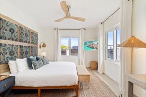 a bedroom with a bed and two windows at 3BR Private Pool Retreat 4 Mins Drive by Bocobay in Palm-Eagle Beach +52 photos