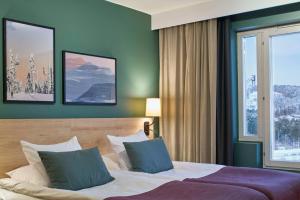 Tempat tidur dalam kamar di Scandic Lugnet