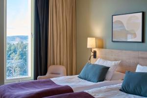 Tempat tidur dalam kamar di Scandic Lugnet
