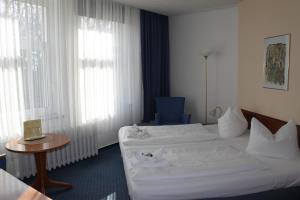 Postel nebo postele na pokoji v ubytování Kur- und Ferienhotel Sanddorn