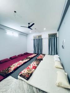 バラナシにあるAnnapurna Homestaysのカーテン付きの客室で、白い大型ベッド1台が備わります。 +13枚の写真