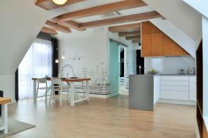 a kitchen and dining room with a table at Apartament Rewa in Rewa