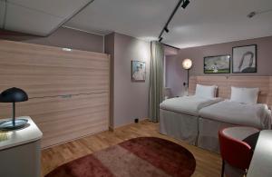 A bed or beds in a room at Scandic Klara