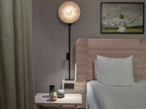 A bed or beds in a room at Scandic Klara