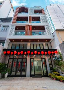 a building with red lanterns in front of it at ANNIE HOUSE Nha Trang- Studio Room convenient & modern design near the beach & Tram Huong Tower with big promo in Nha Trang