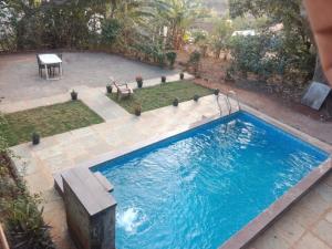 an overhead view of a swimming pool in a backyard at Devansh Villa in Mahabaleshwar