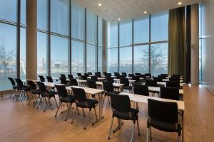 a conference room with tables and chairs and large windows at Scandic Stavanger Airport in Sola