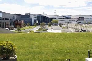 a view of a building with a green lawn at Scandic Stavanger Airport in Sola