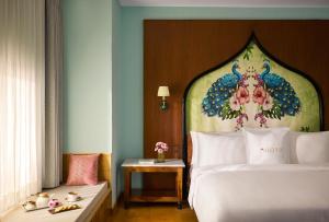 a bedroom with a bed with a peacock painting on it at Storii By ITC Hotels, Jaisalmer in Jaisalmer
