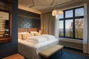 a bedroom with a large bed and a window at Scandic Holmenkollen Park in Oslo