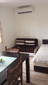 a bedroom with a bed and a table and a table sidx sidx at Studio Stonel in Veliko Tŭrnovo