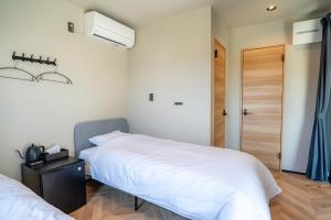 Ένα ή περισσότερα κρεβάτια σε δωμάτιο στο Stay Kumano Kushimoto +8 φωτογραφίες