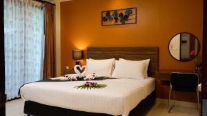 a bedroom with a large bed with flowers on it at Katanoi Resort in Kata Beach