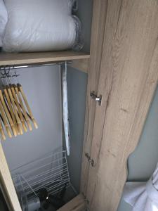 a wooden cabinet with a door in a room at 8 berth Caravan in Morecambe +13 photos