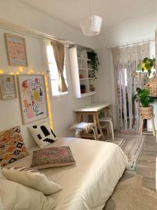 a bedroom with a large bed and a desk at Studio in historical monument in city center in Montpellier +10 photos