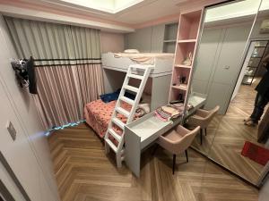 a small room with a desk and a bunk bed at Apartemen capitol suites in Jakarta